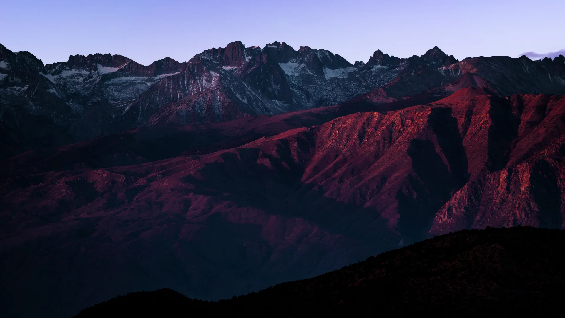 Mountain ridges in shades of purple, from Sh’ma’s original visual identity